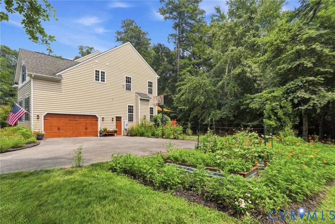 3655 Stone Harbor Drive, Midlothian, VA 23113 Two-story residence featuring light-colored siding, a two-car garage with a wood-finish door, and multiple windows