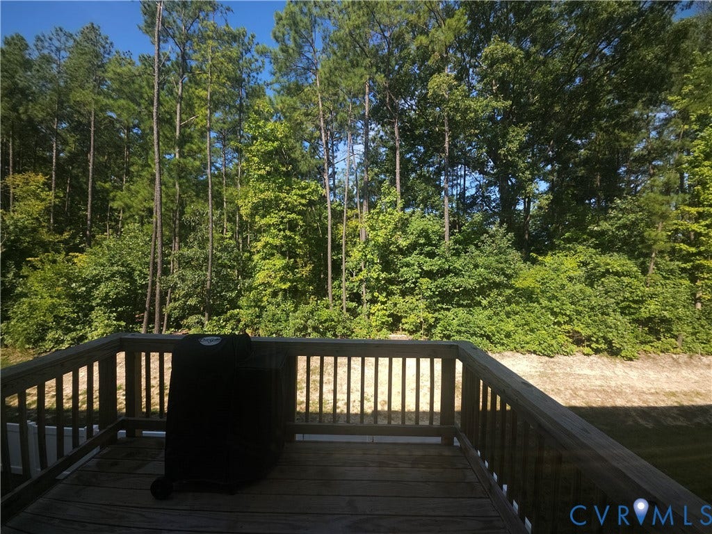 11304 Magill Terrace Drive, Chester, VA 23831 Spacious composite deck with horizontal railings overlooking mature wooded landscape