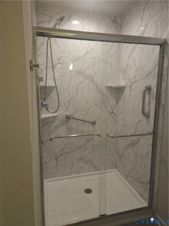 11304 Magill Terrace Drive, Chester, VA 23831 Walk-in shower featuring a white base and marble-patterned wall panels
