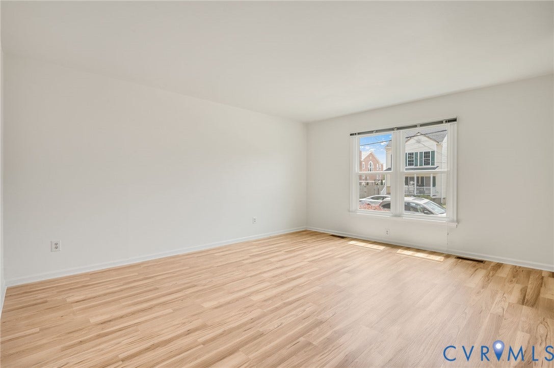 1723 Porter Street, Richmond, VA 23224 Bright room featuring light wood-finish flooring, white walls, and a large double-hung window