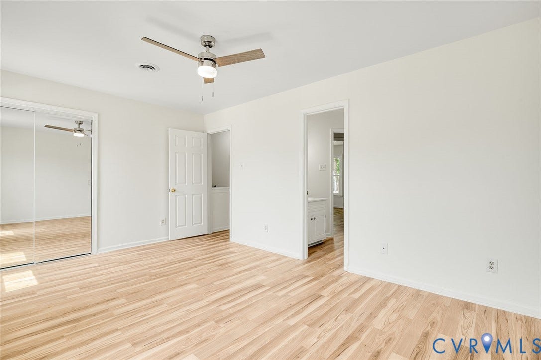 1723 Porter Street, Richmond, VA 23224 Bright room with wood-finish flooring, a ceiling fan with integrated lighting, and mirrored closet doors