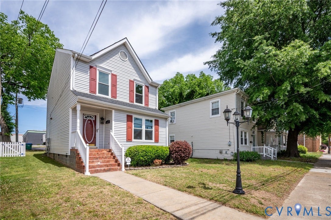 1723 Porter Street, Richmond, VA 23224 Two-story home featuring light grey siding with red window shutters