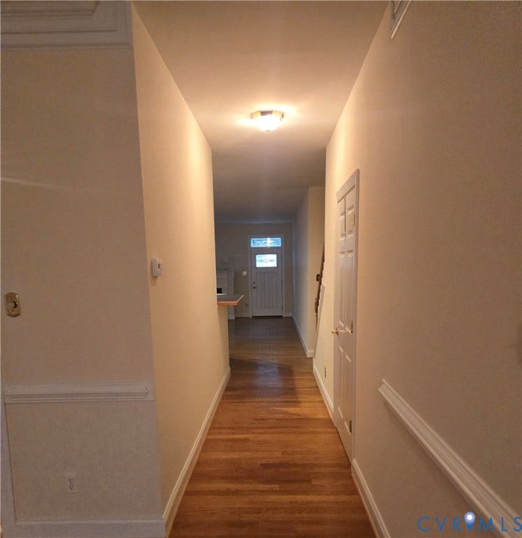 4401 Village Garden Circle, Chester, VA 23831 Hallway featuring warm wood engineered flooring, light-toned walls, decorative chair rail molding, and a flush-mount ceiling light fixture
