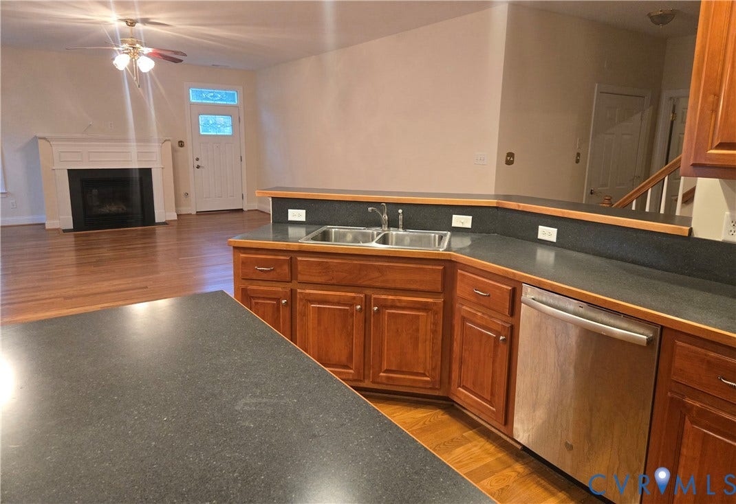 4401 Village Garden Circle, Chester, VA 23831 Kitchen featuring a double stainless steel sink, stainless steel dishwasher, wood-finish cabinetry, and dark countertops