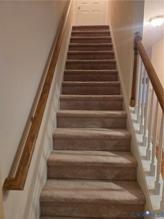 4401 Village Garden Circle, Chester, VA 23831 Carpeted staircase featuring a wooden handrail and white balusters