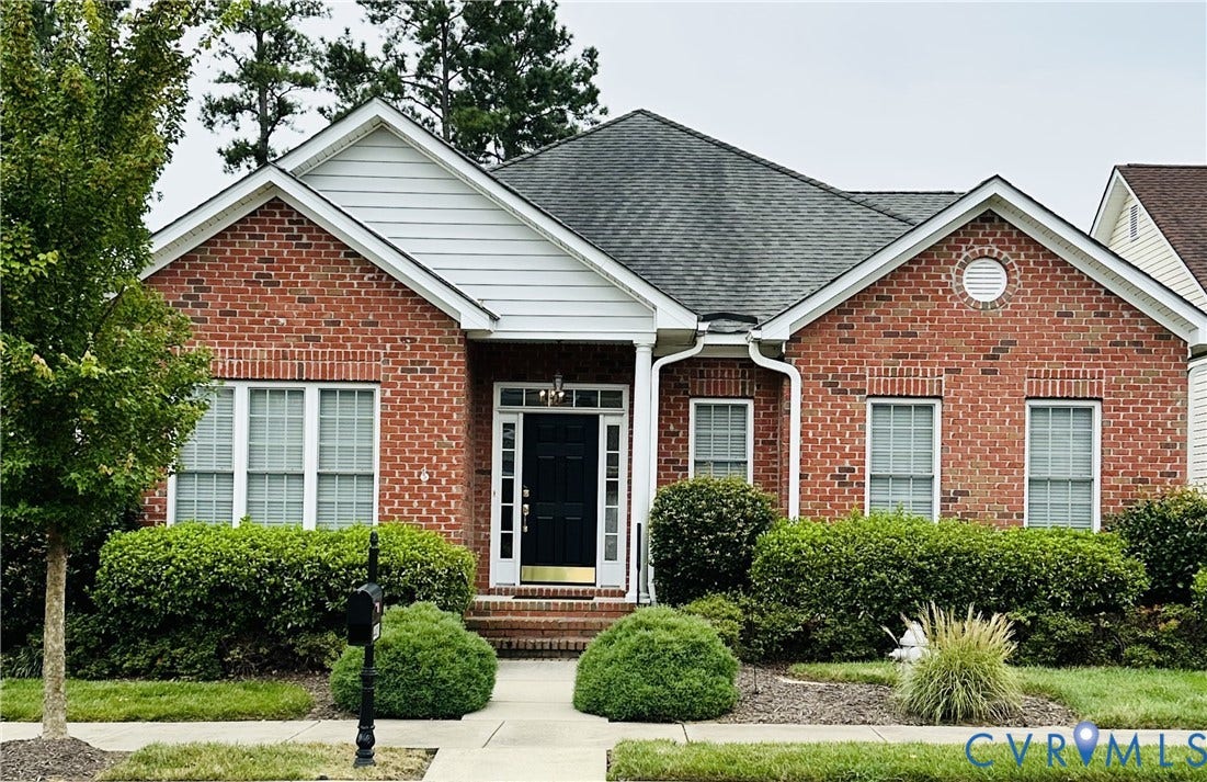 4401 Village Garden Circle, Chester, VA 23831 Brick exterior featuring white trim, a dark entry door, and a covered porch
