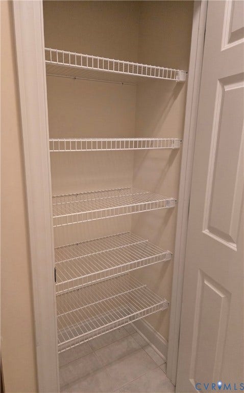 4401 Village Garden Circle, Chester, VA 23831 Primary Closet in bathroom featuring five wire shelves and light-toned tile flooring
