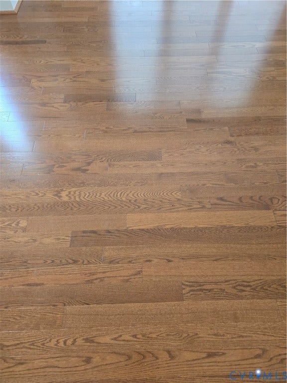 4401 Village Garden Circle, Chester, VA 23831 Warm-toned wood-finish flooring featuring varied grain patterns