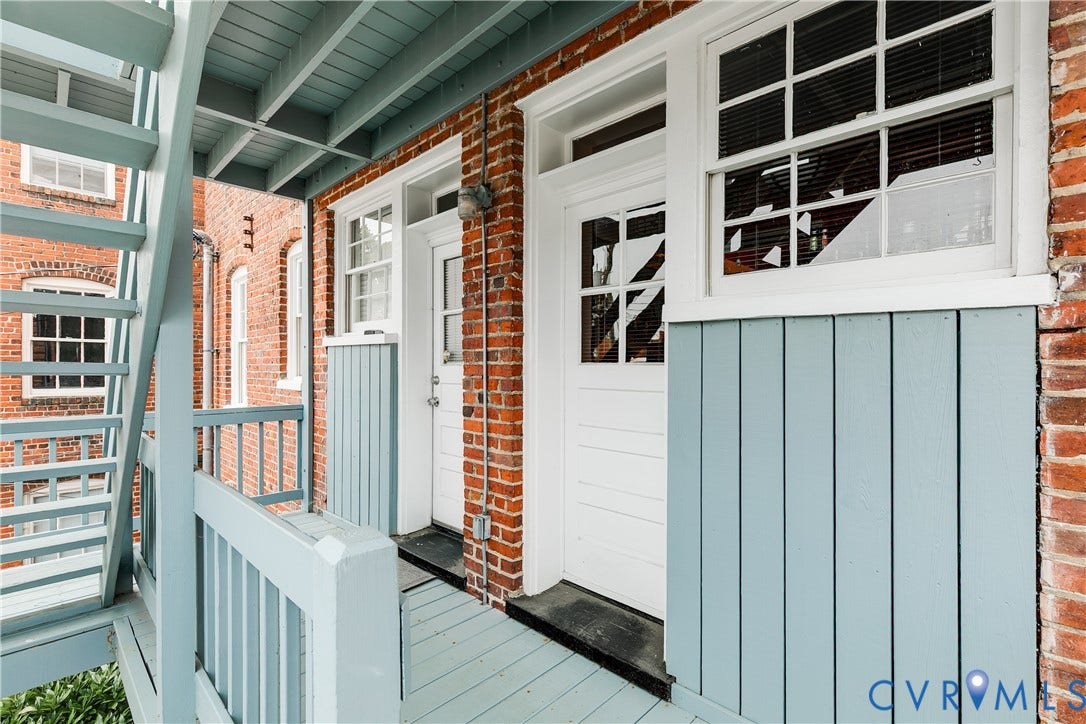 3006 Monument Avenue, #U2W, Museum District, Richmond, VA 23221 Exterior balcony with painted wood flooring and railings, featuring brick construction and light blue vertical siding