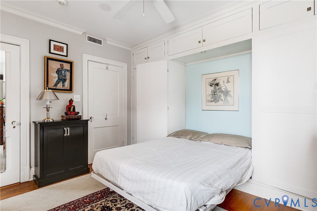3006 Monument Avenue, #U2W, Museum District, Richmond, VA 23221 Integrated wall cabinetry with a built-in bed frame, light blue accent wall, hardwood flooring, and crown molding