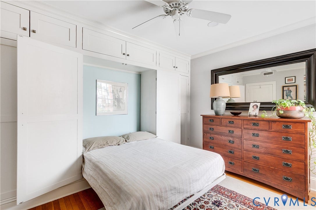 3006 Monument Avenue, #U2W, Museum District, Richmond, VA 23221 Integrated wall storage with white cabinetry, a built-in folding bed, and a ceiling fan with light fixture