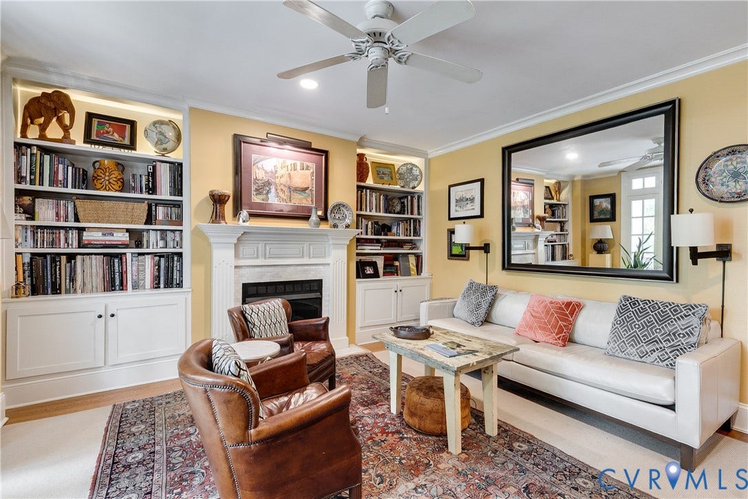 3006 Monument Avenue, #U2W, Museum District, Richmond, VA 23221 Living space featuring a mantel, built-in shelving, crown molding, a ceiling fan, and wood-finish flooring