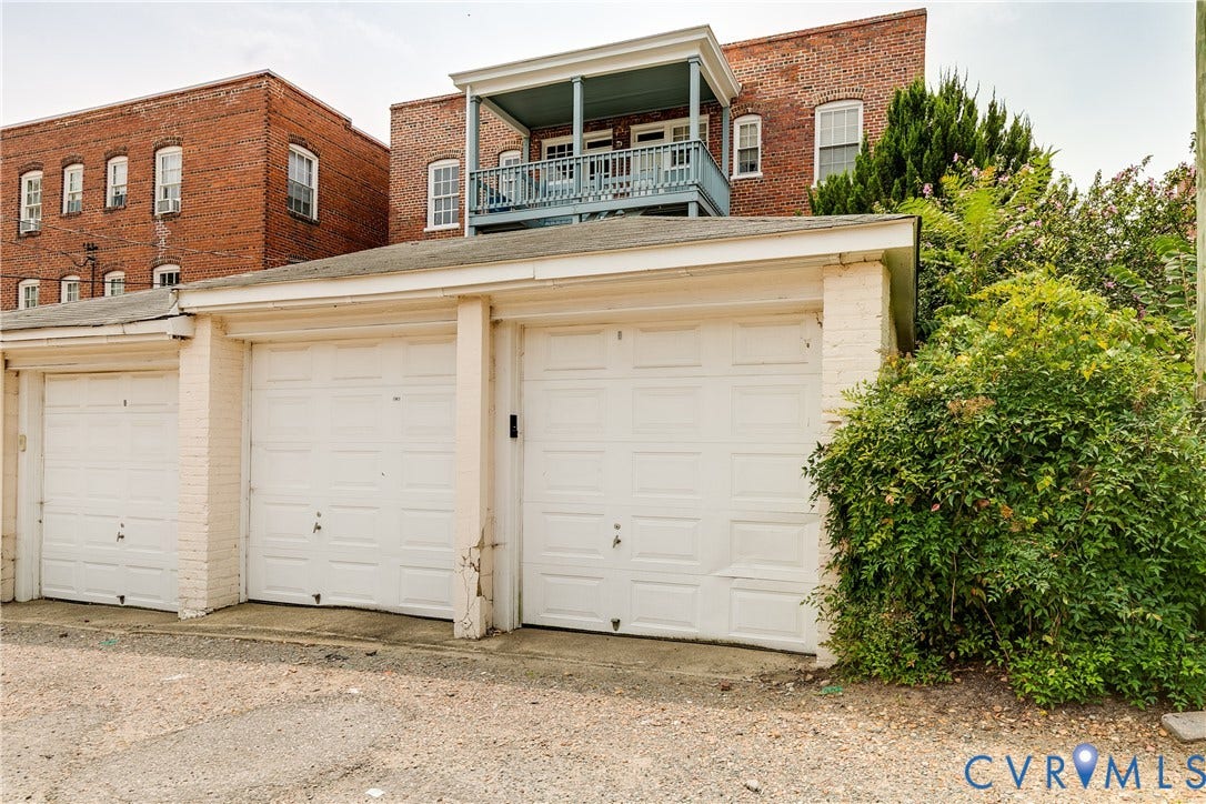 3006 Monument Avenue, #U2W, Museum District, Richmond, VA 23221 Three individual garage bays with white panel doors and painted brick surrounds