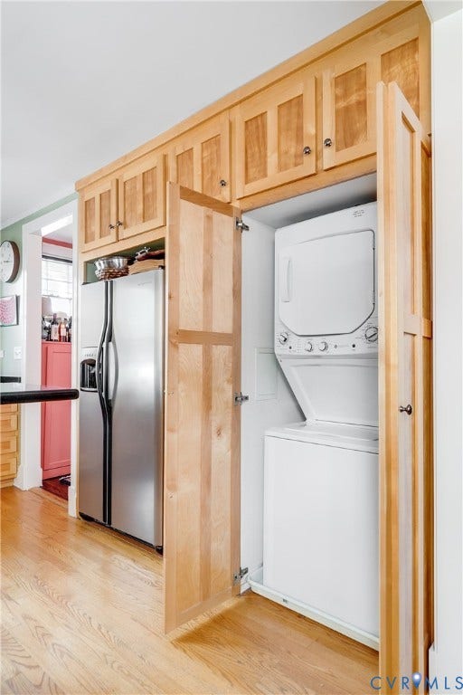 3006 Monument Avenue, #U2W, Museum District, Richmond, VA 23221 Integrated laundry area featuring a stacked washer and dryer, complemented by natural wood cabinetry