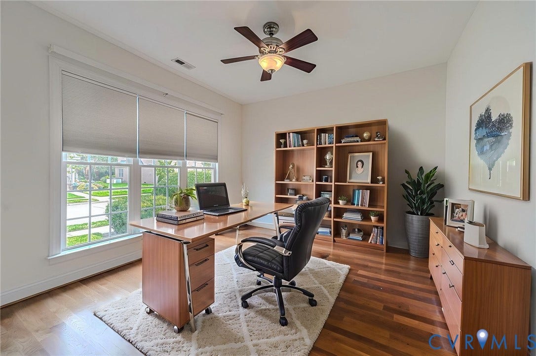 4309 Village Creek Drive, Chester, VA 23831 Spacious room featuring wood-finish flooring, a multi-pane window with roller shades, and a ceiling fan with integrated lighting