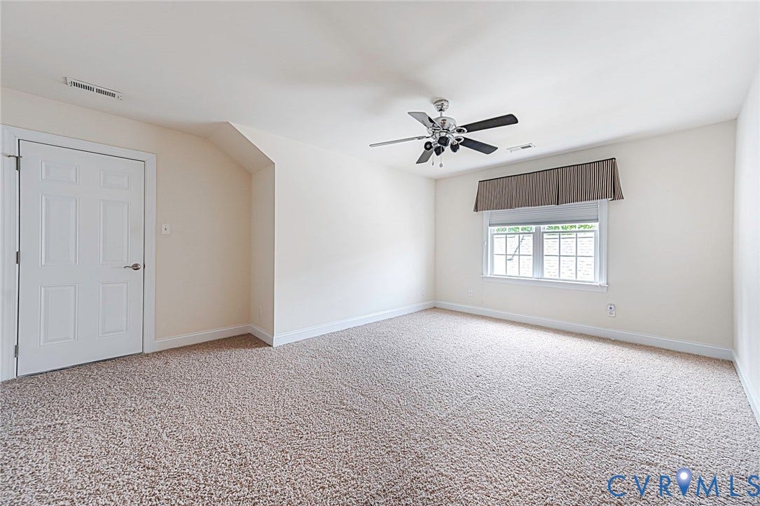 4309 Village Creek Drive, Chester, VA 23831 large 3 rd bedroom, Spacious featuring neutral carpeting, a multi-pane window with a valance, and a ceiling fan, walk in attic, closet