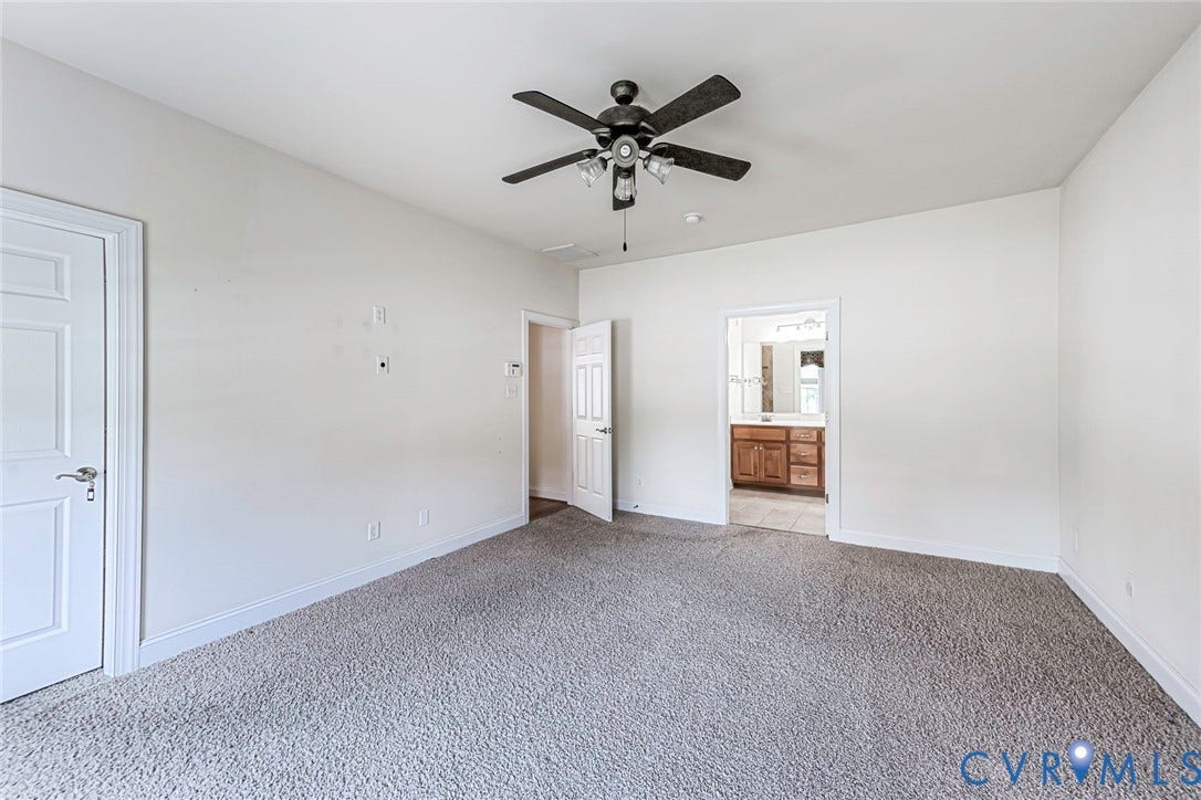 4309 Village Creek Drive, Chester, VA 23831 Primary bedroom spacious room featuring neutral carpeting, walk in closet, paddle fan/light and large primary bathroom.