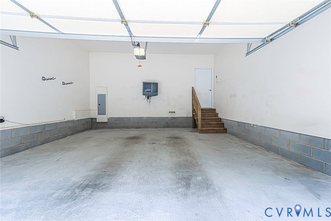 4309 Village Creek Drive, Chester, VA 23831 Spacious finished garage with a concrete floor, 2 garage door openers.