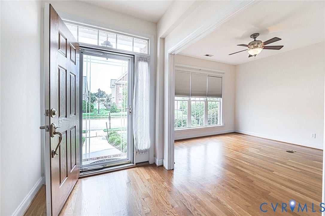 4309 Village Creek Drive, Chester, VA 23831 Entryway featuring a paneled wood door, transom window, and wood-finish flooring