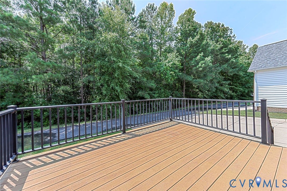 4309 Village Creek Drive, Chester, VA 23831 Spacious outdoor rear trex deck featuring composite decking and black metal railings