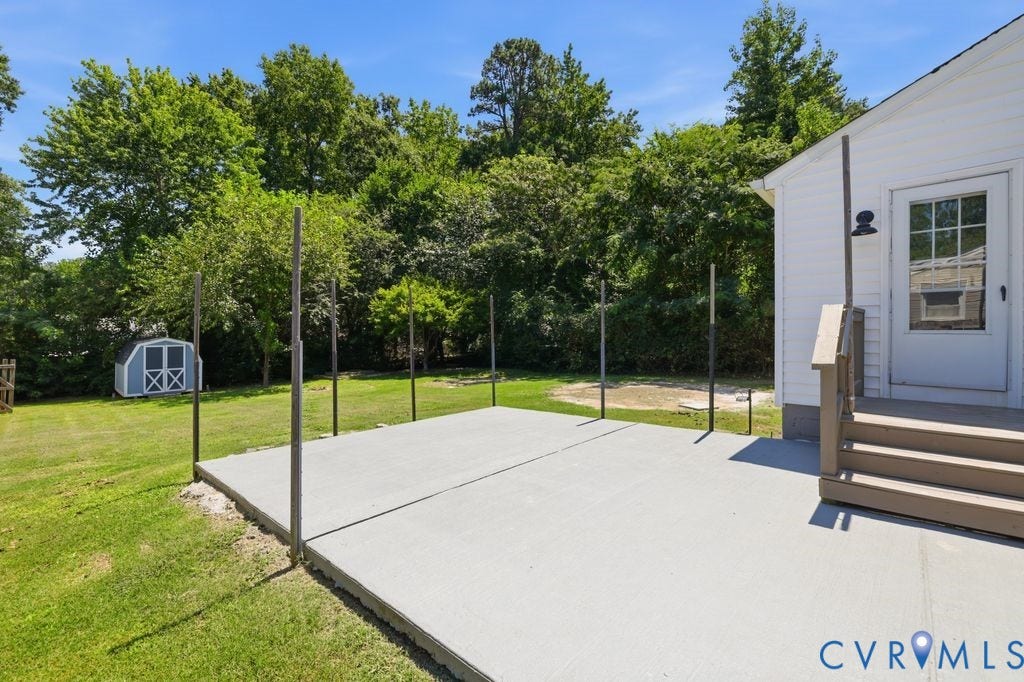 Expansive concrete patio with multiple vertical posts, ideal for overhead coverings