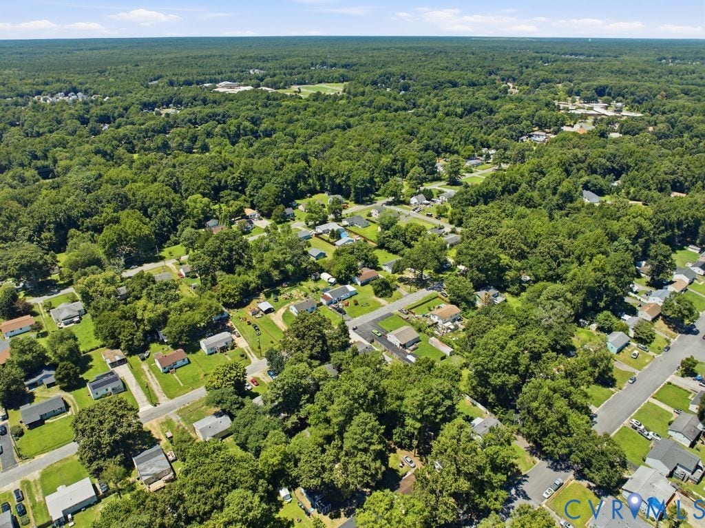 Expansive aerial view showcasing a residential area amidst abundant mature trees