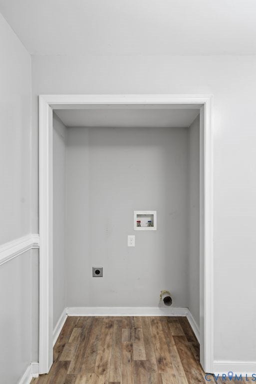 Dedicated laundry area with hookups, wood-finish flooring, and light gray walls
