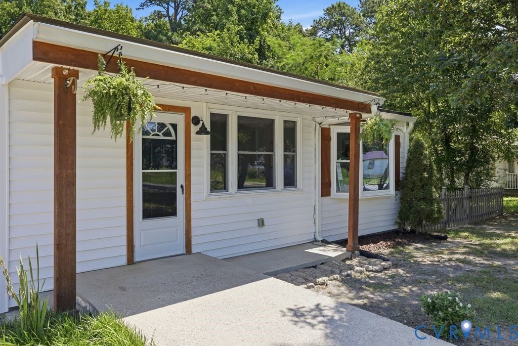 White siding exterior with a covered front entry