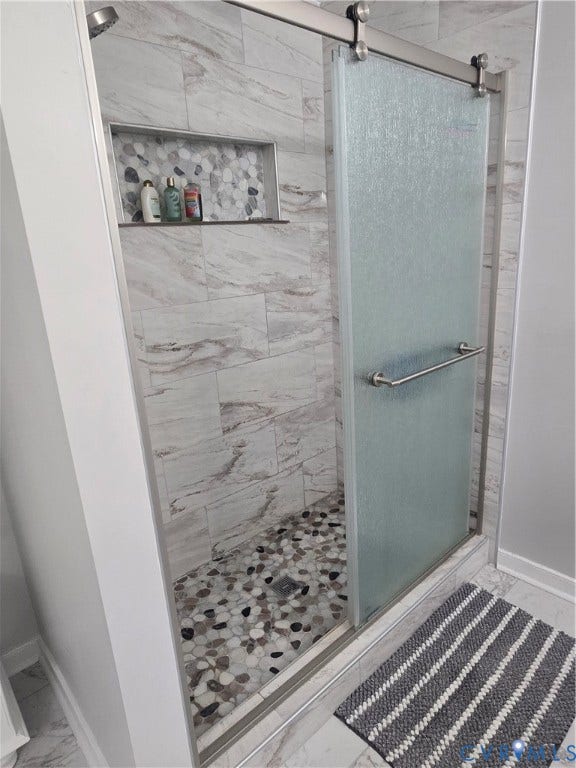 12812 Winfree Street, Chester, VA 23831 Walk-in shower featuring a sliding frosted glass door, ceramic tile shower and floor, renovated last year.