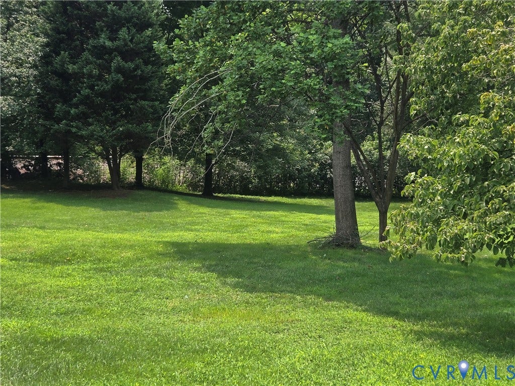 12812 Winfree Street, Chester, VA 23831 Expansive lawn area featuring established trees and lush greenery, irrigation system