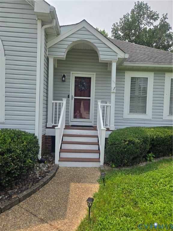 12812 Winfree Street, Chester, VA 23831 Welcoming entry featuring a covered porch with an arched soffit, white railings, and a red front door