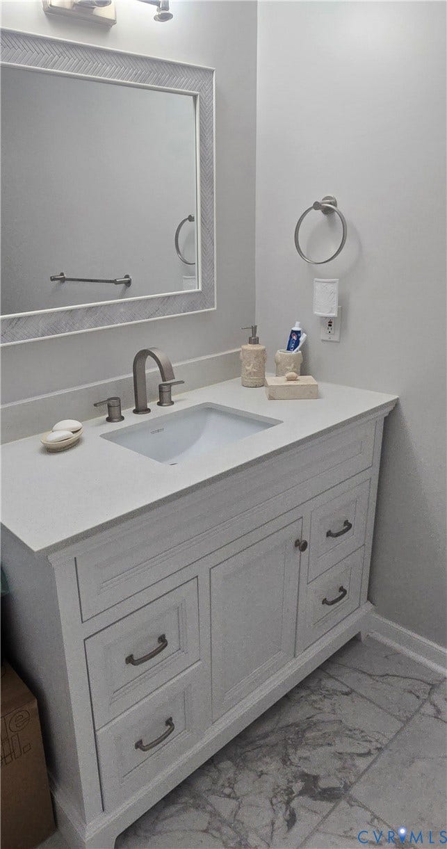 12812 Winfree Street, Chester, VA 23831 White vanity with integrated sink, stone countertop, brushed nickel faucet, and coordinating cabinet hardware