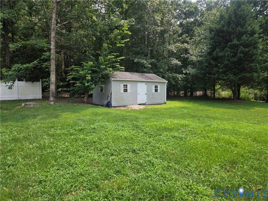 12812 Winfree Street, Chester, VA 23831 Expansive green space featuring a detached storage shed with a white door and windows
