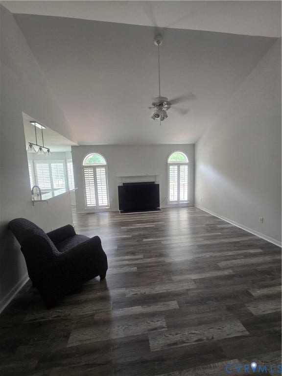 12812 Winfree Street, Chester, VA 23831 Spacious living area featuring vaulted ceilings, wood-finish flooring, and a ceiling fan, propane gas fireplace