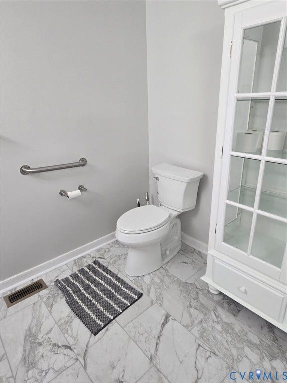 12812 Winfree Street, Chester, VA 23831 featuring l-in white display cabinet, ceramic tile floor, higher toilet, renovated last year