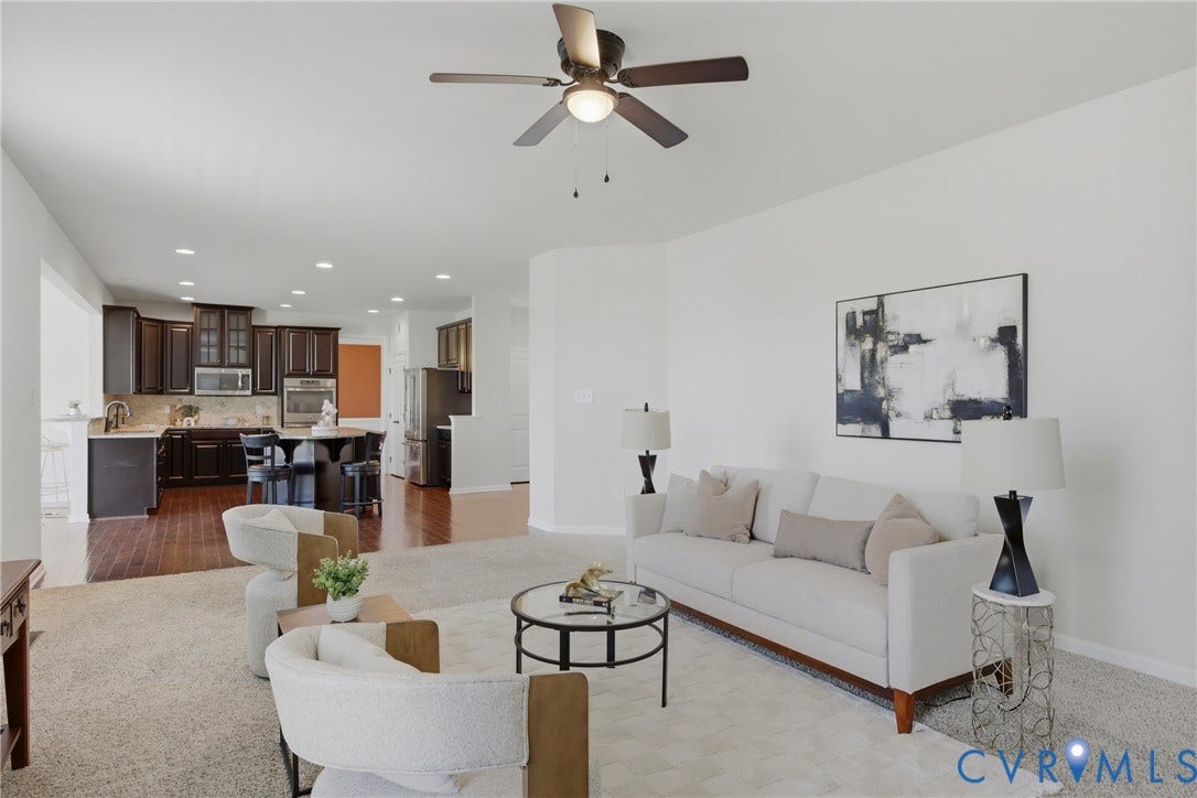 1819 White Mountain Drive, Mount Blanco On The James, Chester, VA 23836 Open concept living area featuring a ceiling fan, recessed lighting, and a kitchen with dark wood cabinetry, a central island, and stainless steel appliances