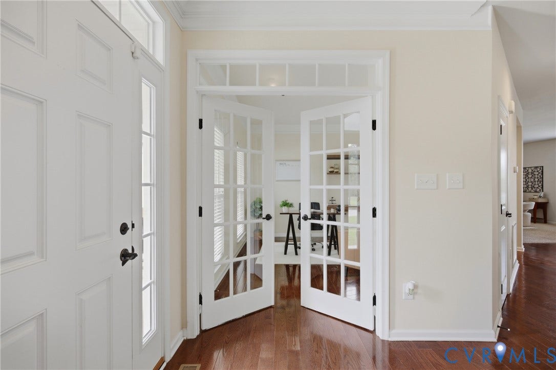 1819 White Mountain Drive, Mount Blanco On The James, Chester, VA 23836 Entryway featuring an architectural transom window above the main door, rich wood-finish flooring, white trim, and a pair of French doors with clear glass panes opening into an interior space
