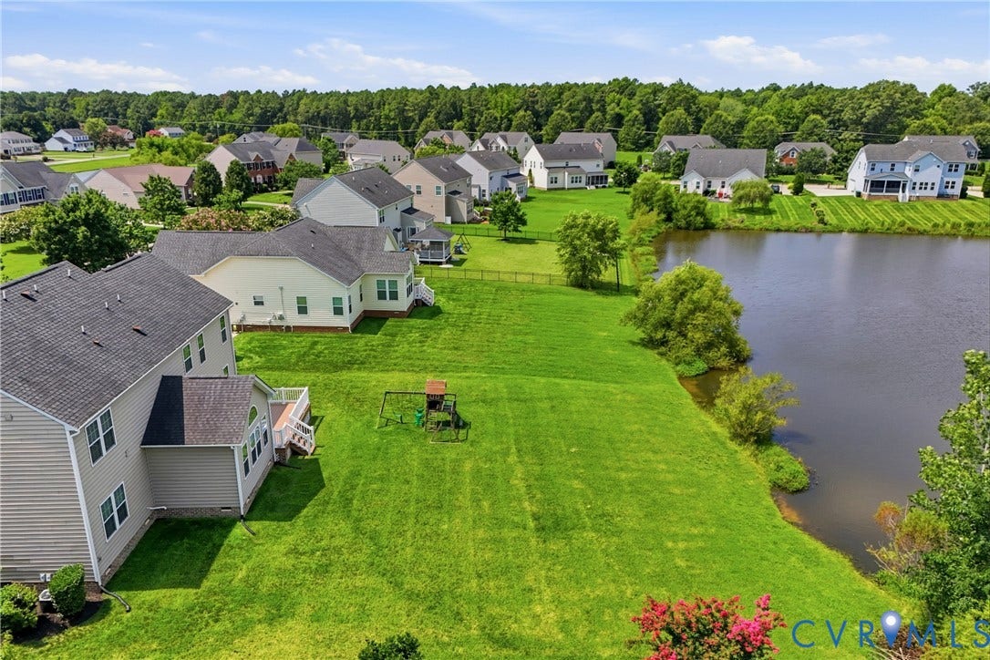 1819 White Mountain Drive, Mount Blanco On The James, Chester, VA 23836 Spacious backyard featuring a large green lawn and direct access to a natural body of water