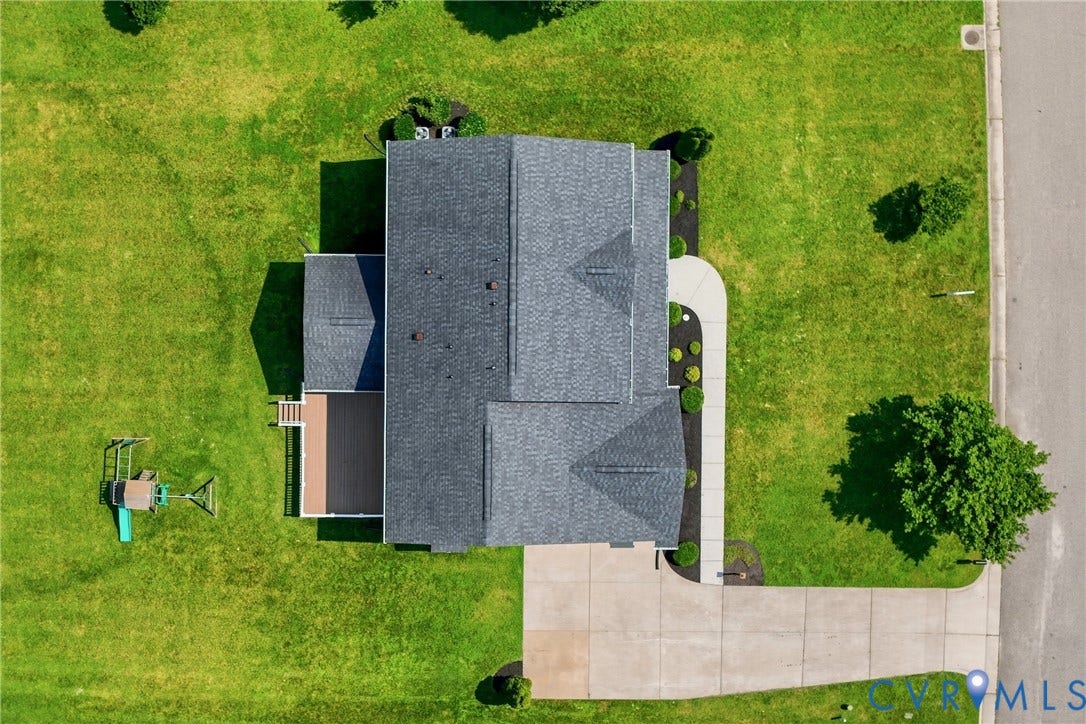 1819 White Mountain Drive, Mount Blanco On The James, Chester, VA 23836 Aerial perspective showcasing a property with a gray shingle roof, a spacious concrete driveway, and a curved concrete walkway