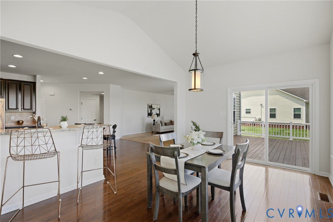1819 White Mountain Drive, Mount Blanco On The James, Chester, VA 23836 Dining area featuring wood-finish flooring, vaulted ceiling, and a lantern-style pendant light