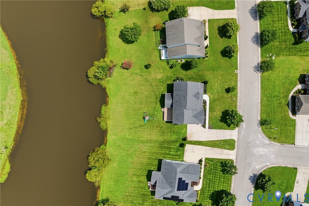 1819 White Mountain Drive, Mount Blanco On The James, Chester, VA 23836 Aerial perspective showcasing a residential area with properties bordering a substantial body of water