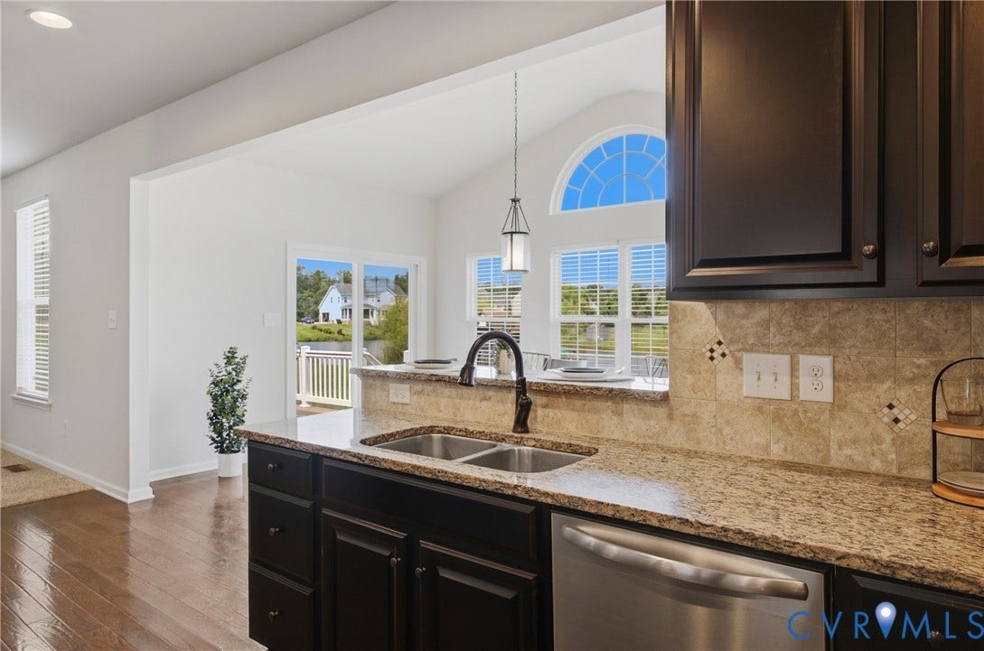 1819 White Mountain Drive, Mount Blanco On The James, Chester, VA 23836 Kitchen featuring dark wood cabinetry, a double basin stainless steel sink, and stainless steel appliance