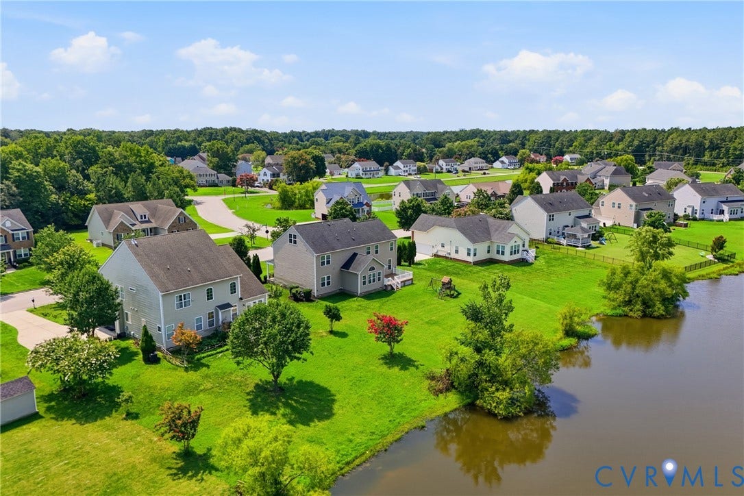 1819 White Mountain Drive, Mount Blanco On The James, Chester, VA 23836 Expansive neighborhood setting featuring a serene pond