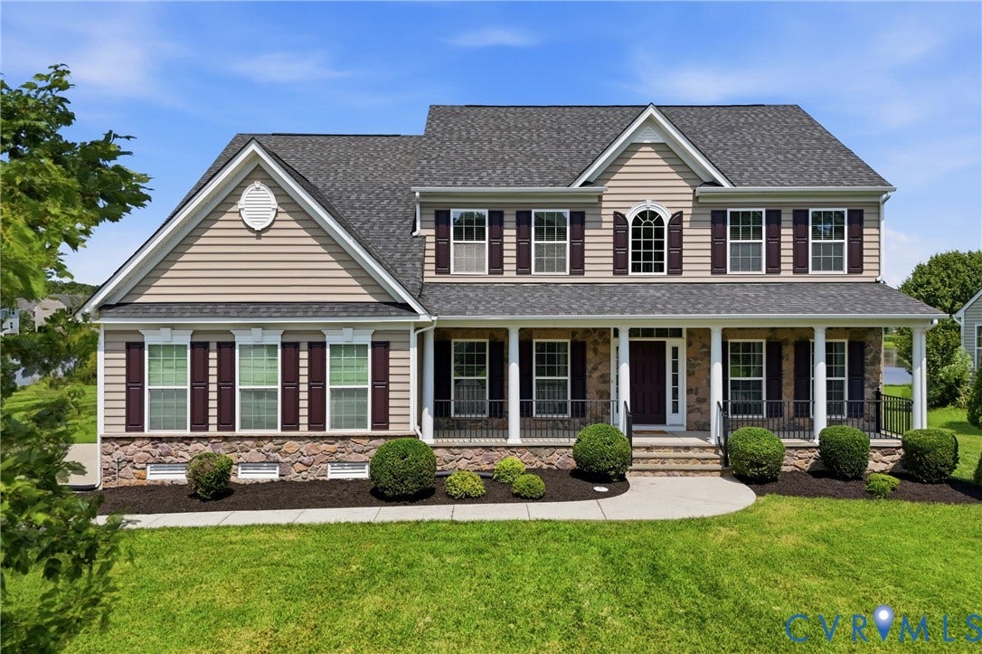 1819 White Mountain Drive, Mount Blanco On The James, Chester, VA 23836 Traditional-style residence featuring a prominent front porch with white columns, dark shutters, and stone veneer accents
