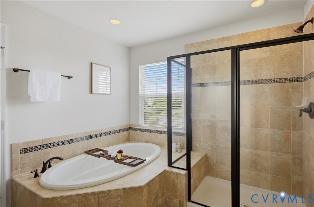 1819 White Mountain Drive, Mount Blanco On The James, Chester, VA 23836 Bathroom featuring a built-in soaking tub and a separate glass-enclosed shower