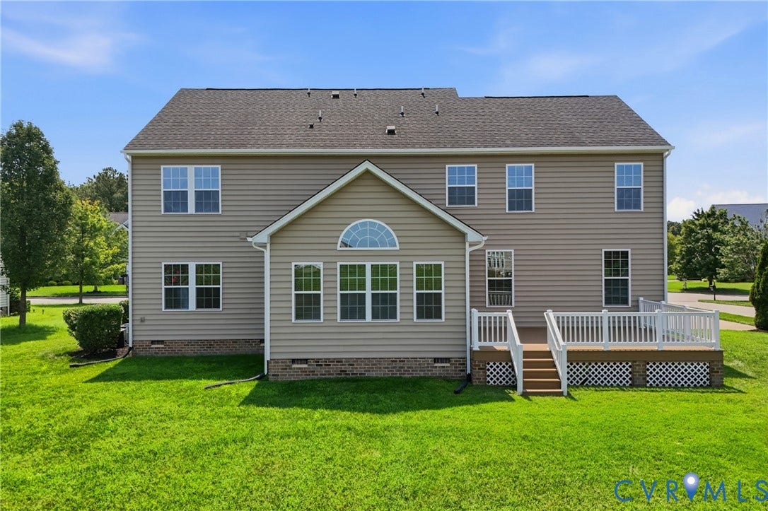 1819 White Mountain Drive, Mount Blanco On The James, Chester, VA 23836 Rear exterior featuring a sunroom, multi-level decking with white railings, and a spacious green lawn