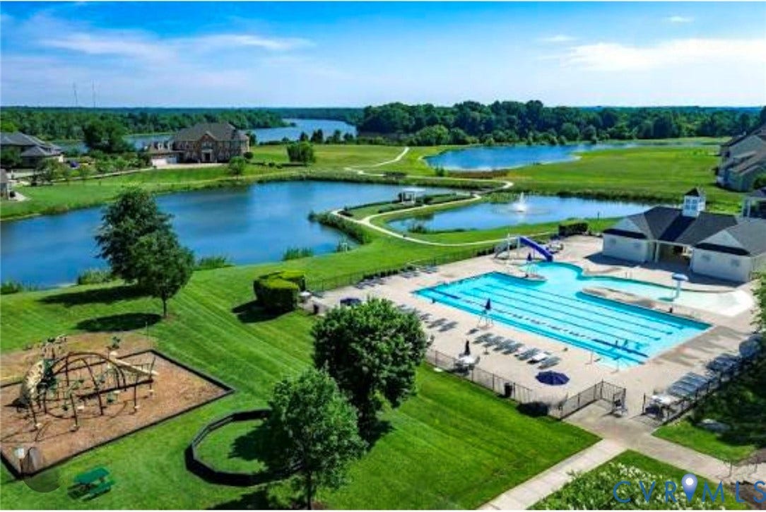 1819 White Mountain Drive, Mount Blanco On The James, Chester, VA 23836 Community amenities featuring a large outdoor swimming pool with lap lanes and a separate wading area, an adjacent clubhouse building, and a dedicated playground area