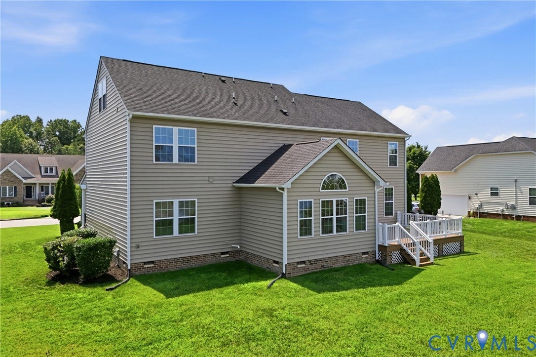 1819 White Mountain Drive, Mount Blanco On The James, Chester, VA 23836 Rear exterior featuring tan horizontal siding and a dark shingle roof