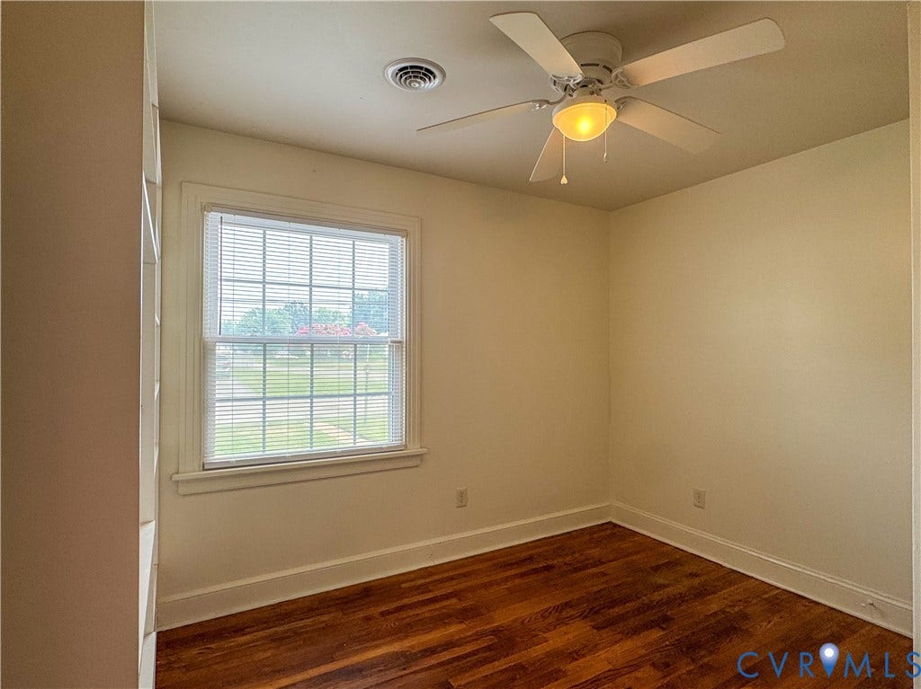 Warm wood-finish flooring complements the neutral wall tones