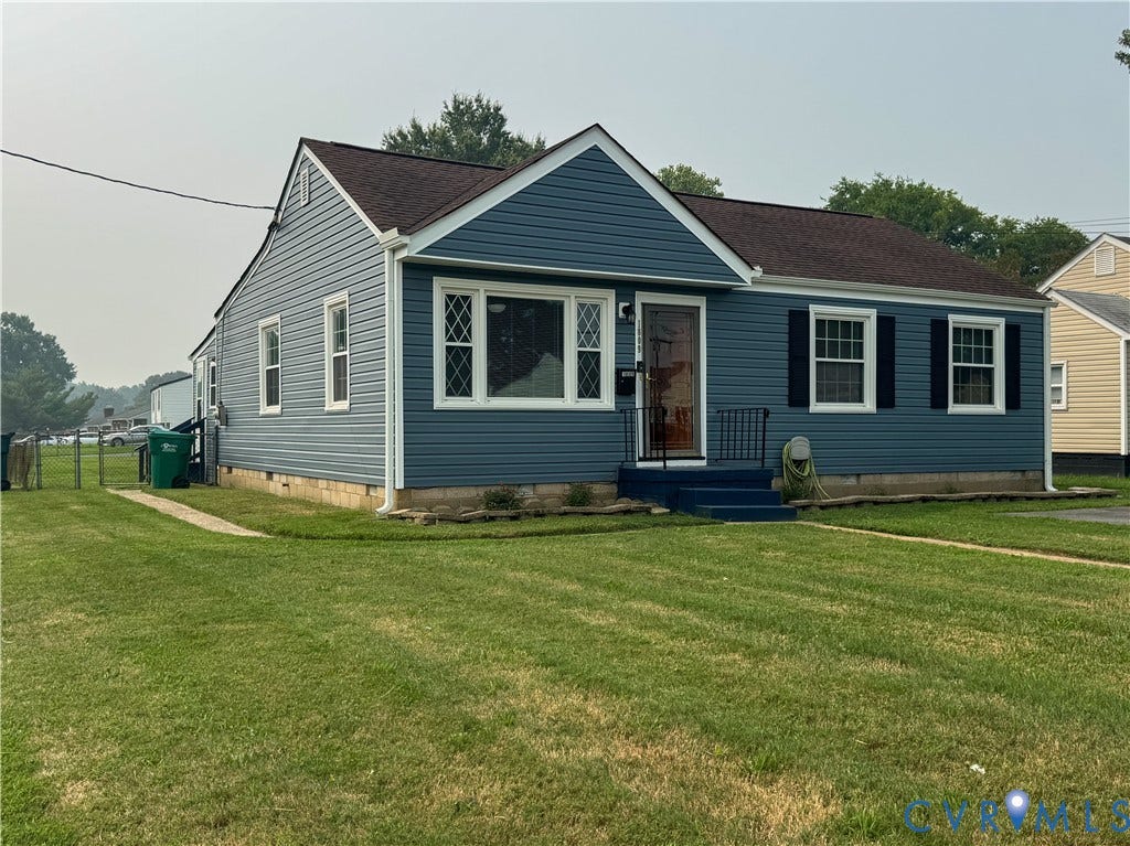 Ranch-style residence featuring blue horizontal siding and a dark brown shingle roof